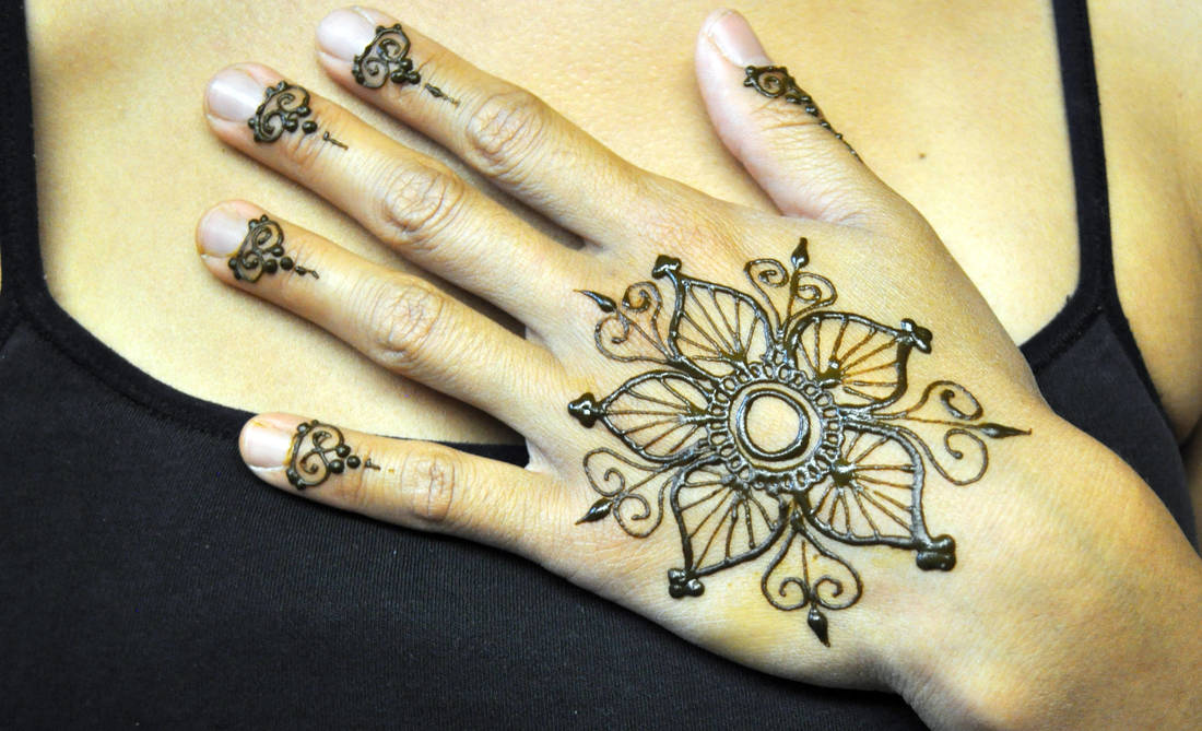henna flower on hand